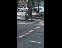 Lady poses in middle of street with bread 