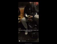 Man eats an avocado like an apple on subway train