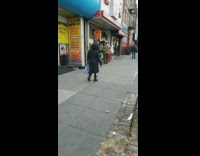 Man dances outside of store to reggae music 