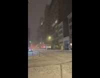 Black SUV car on empty snow covered road drifting doing circles 
