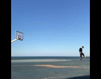 Guy shoots a ball backwards with his feet 