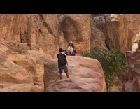 Girl checkered bandana sit over large rock