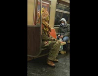 Guy on subway funky homemade plastic hat 