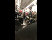 Guy black hoodie smokes a blunt on crowded subway train