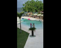 Lady Walks Around Pool and Holds Mans Hand
