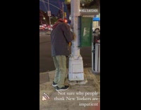 Guy keeps presses street walk button 