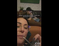 Girl drinks from cup and to say delicious with mouth full of liquid water 