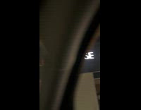 Woman laughs at flix brewhouse light sign