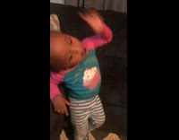 Two little girls sing and shake their butts to song on the couch