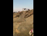Woman green jacket bend over metal chain