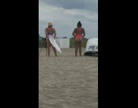 Orange bathing suit girl beach sand boat