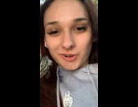 Lady Smiles as she Holds Up Turtle