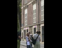 Woman in white top poses with a baguette bread in the park