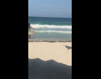 Bikini girl runs spins beach shore flag 