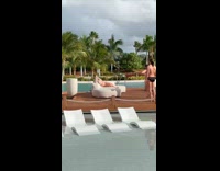 Woman bikini lie down pose poolside couch