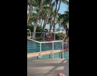 Blonde woman white bikini bite sunglasses pool