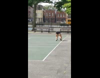 Guy walks on all fours across outdoor court 