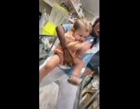 Woman carries baby who dances with her 