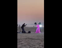 Pregnant woman dance beach pink skirt sunset