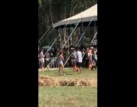 Guy throws woman into a backflip and falls on ground at concert festival