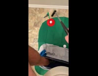Guy sitting on toilet plays golf game 