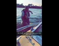 Man life vest prepares to jump into shallow water