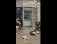 Guy play cello while old man dance subway