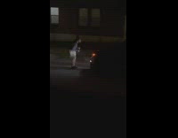 Woman dance on street night behind car