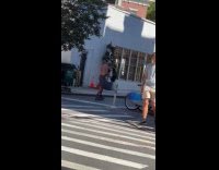 Shirtless man rides skateboard on the street