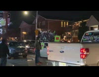 People look at christmas lights car bicycles 