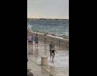 Man and woman barrier large beach waves Part 1