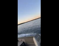 Guy falls off wakeboard grey boat sunset 