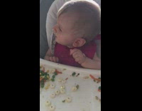 Little baby boy in high chair watching guy run sideways stomp
