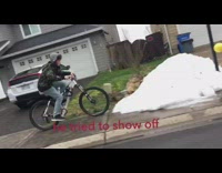 kid rides bicycle sidewalk snow show off  