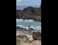 Woman pink bikini wave two flags beach