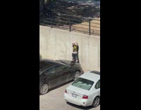 Girl black shirt hold hair in front of car