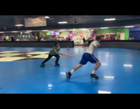 Football player plays games on roller rink 