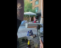 Guy drop phone on girl white umbrella