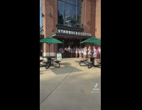 Line of girls in pink white uniform starbucks 
