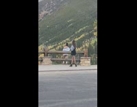 Blue jacket girl poses mountain parking lot 
