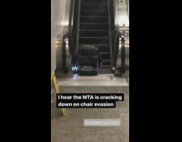 Black desk chair at the bottom of escalator in subway station