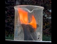 Black sock burn inside a glass beaker