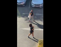 Woman black shirt side pose parking lot