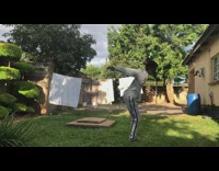 Slow motion of guy in grey sweat suit doing a back flip 
