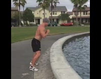 guy jump squats next to fountain falls in