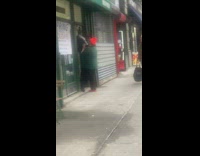 Guys carrying giant cow statue into store