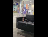 Three women in the same outfit crouches slowly together