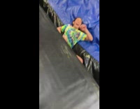Girl jumps and hangs onto punching bag at trampoline park and falls into crack