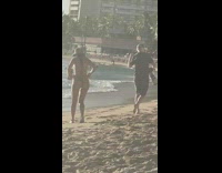 Photographer big camera woman walk beach hat