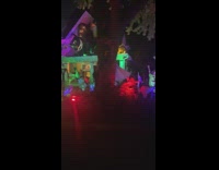 Woman drives by a house with Halloween decor